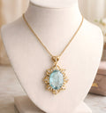 Aquamarine and diamond halo pendant necklace