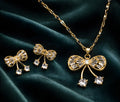 Elegant gold-toned bow pendant set